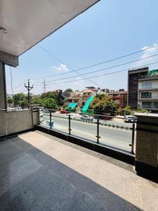 a balcony with a view of a river and buildings at ADA Residency in Noida
