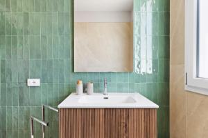 a bathroom with a sink and a mirror at Brezza Apartments in Santa Flavia +93 photos