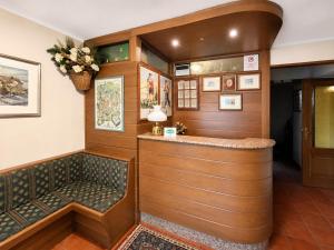 a bar in a room with wood paneling at Albergo Al Laghetto B&B in Asiago