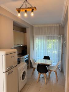 a kitchen with a table and chairs and a refrigerator at Marinas view apartment in Limenas