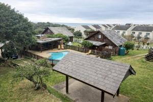 an aerial view of a home with a pool and a house at Beach Cabin with a pool in Port Alfred
