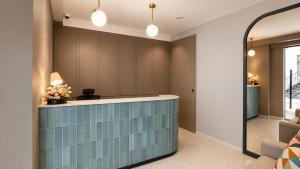 a lobby with a blue tile counter in a room at ISA Hotel Amber Road in Singapore +26 photos