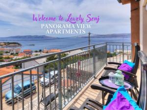 a balcony with a table and chairs and a view of the water at LOVELY APARTMENTS Senj - Spectacular Sea View & Free Parking & WI-FI in Senj