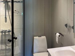 a bathroom with a shower and a toilet and a sink at 4 person holiday home in OMASTRAND-By Traum in Sanddal +38 photos
