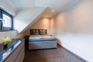 a bedroom with a bed in a attic at Lara Prime in Zepkow
