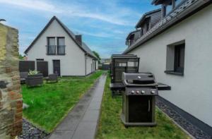 a barbecue grill on the side of a house at Lara Prime in Zepkow