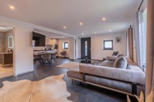 a living room with a couch and a kitchen at Lara Prime in Zepkow