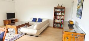a living room with a couch and a table and a tv at Ferienhaus Panoramablick Altfalter in Schwarzach bei Nabburg
