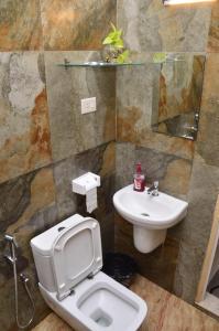 a bathroom with a toilet and a sink at Nirrvaan homestay in Varkala
