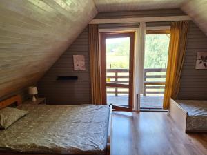 a bedroom with a bed and a large window at Palmas in Jūrkalne