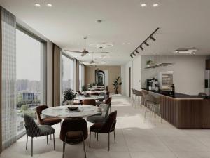 a restaurant with tables and chairs and a counter at Olivia Hotel in Ấp Thành