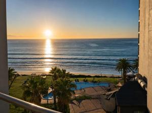 a view of the ocean from the balcony of a resort at 501 Beach Club in Mossel Bay