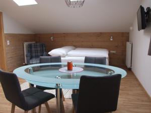 a room with a table and chairs and a bed at Ferienwohnungen Kindl in Neustift im Stubaital