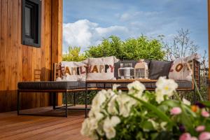 a couch on a deck with a blanket on it at tiny house Eisingen in Eisingen