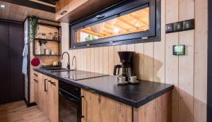 a kitchen with a counter and a sink and a window at tiny house Eisingen in Eisingen