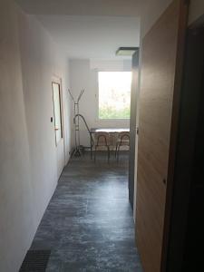 a hallway with a table and chairs in a room at Apartmán Zdislava in Česká Ves