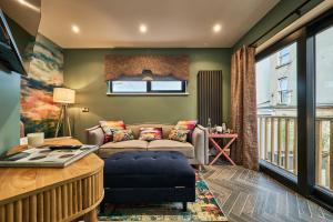 a living room with a couch and a table at Art House in Derry Londonderry