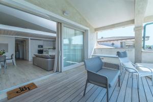a living room with a view of a house at Residence il Gabbiano in Palau