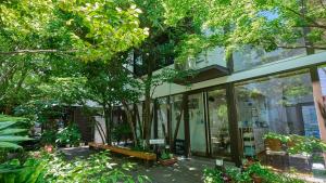 a glass building with a bench in front of it at Shinwaso Kaishin in Amakusa
