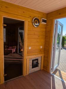 a log cabin with a fireplace in a room at Zaķēni in Āboliņi +13 photos