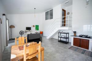 a living room with white walls and a staircase at Wild Vanilla Apartment in Beau Vallon