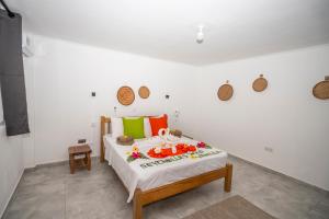 a bedroom with a bed in a white wall at Wild Vanilla Apartment in Beau Vallon