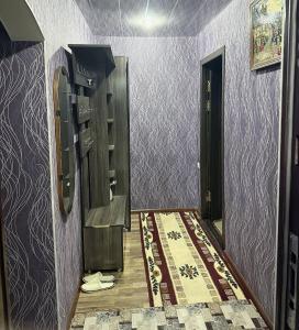 a room with a hallway with a door and a rug at Тихий дом in Fergana