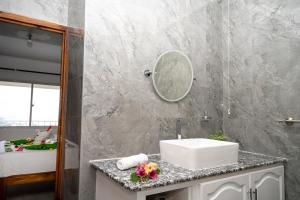 a bathroom with a sink and a mirror at Wild Vanilla Apartment in Beau Vallon +51 photos