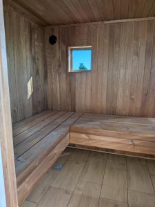 a sauna with a bench in a wooden room at Zaķēni in Āboliņi