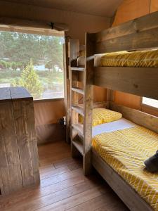 a bedroom with two bunk beds and a window at Quinta do Rio Alva and Glamping Lodges in Mouronho +161 photos