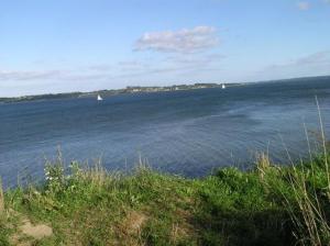 a large body of water with two boats in it at Ferienhaus 'Seeblick 39' in Glücksburg