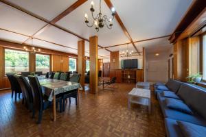 a dining room and living room with a table and chairs at Les Sources - 30 personnes in Bussang