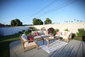 a patio with two couches and a coffee table at Awesome 5 bedroom 3 bath pool home with in-ground jacuzzi in Orange
