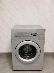 a washer and dryer in a room at Datka Hotel in Bishkek