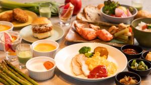 a table with plates of food and bowls of different foods at Sapporo Prince Hotel in Sapporo