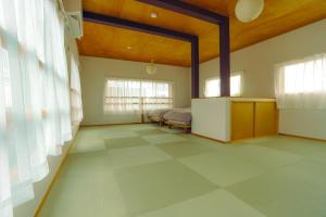 a large room with a bed and a tiled floor at 浬-kairi-1852 in Choshi
