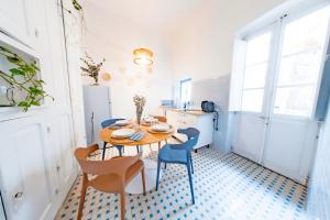 a dining room with a table and chairs at Inderooms Carloforte in Carloforte