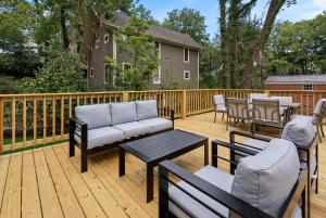 a patio with a couch and chairs on a wooden deck at Family Friendly 4BR Oxford Home Near The Square in Oxford