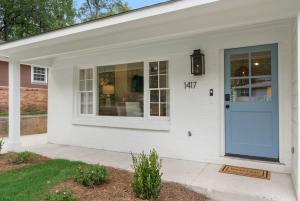 a white house with a blue door on it at Family Friendly 4BR Oxford Home Near The Square in Oxford +53 photos