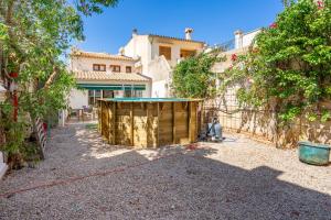 a backyard with a building with a pool in it at Sant Antoni 39 in Llucmajor