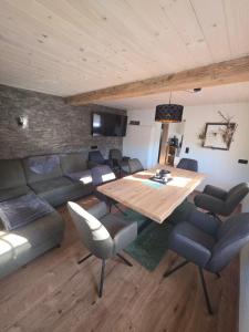 a living room with a wooden table and a couch at Ferienwohnung Loifried in Abtenau