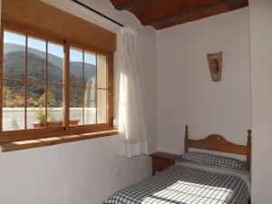 Ένα ή περισσότερα κρεβάτια σε δωμάτιο στο Alojamiento Rural Medios Panes