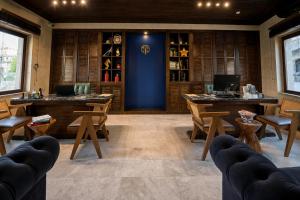 a room with wooden tables and chairs and a blue wall at Luvi Cave Hotel in Göreme