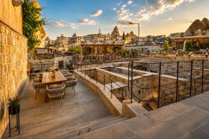 a balcony with a table and chairs and a view of the city at Luvi Cave Hotel in Göreme