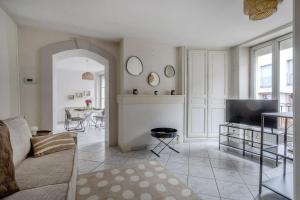 a living room with a couch and a television at La Ferté - Centre-ville - Petfriendly in La Ferté-Bernard