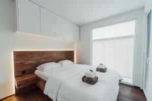 a bedroom with a large bed with two stuffed animals on it at Modern Seaside House in Pakoštane