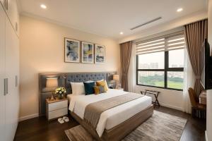 a bedroom with a large bed and a window at Vinhomes D'capitale Hanoi Opus in Hanoi +100 photos