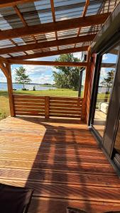 a wooden porch with a view of the ocean at Mazurski Widok 2 in SzczybaÅ‚y OrÅ‚owskie