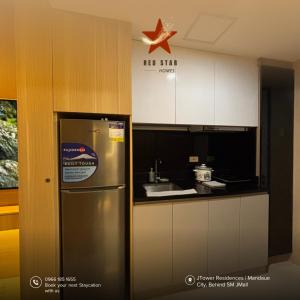 a kitchen with a refrigerator and a star on the wall at JTower Residences Mandaue in Mandaue City
