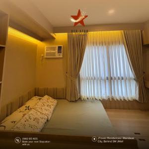 a bedroom with a bed with a star on the ceiling at JTower Residences Mandaue in Mandaue City